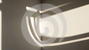 Geometric shadows on a corner of a room, creating patterns of light