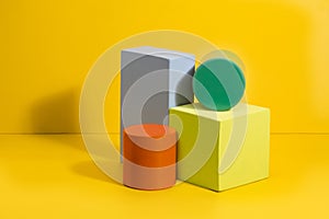 Geometric shapes in different colors on yellow background.