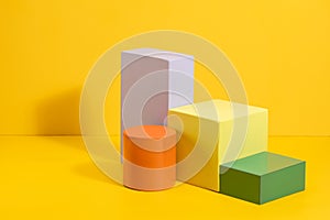 Geometric shapes in different colors on yellow background.