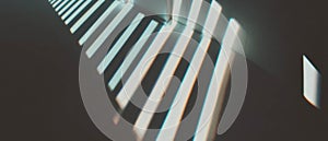 Shadows of window frames create geometric patterns on a dark background photo