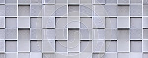 Geometric square pattern background of expanded aluminium grating wall decoration outside of modern building in panoramic view
