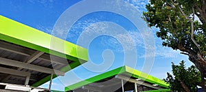 geometric square shape roof top green color on steel structure on blue sky white cloud abstract nature background