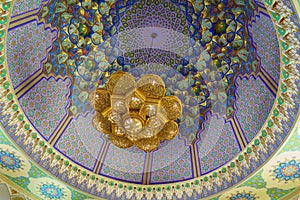Geometric traditional Islamic ornament and domed ceiling chandelier. Fragment of a ceramic mosaic.