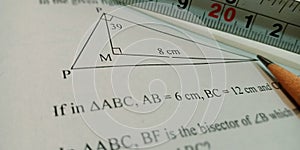 geometric triangle displayed on white paper with pencil pointer