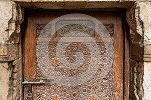 Aged wooden engraved door of El Korafi historic mosque, signed by the maker, Cairo, Egypt photo