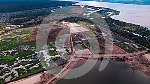 Geometrical silt grounds near sand quarry on river bank