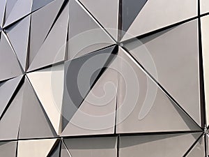 Geometrical triangular shape on metal building wall photo