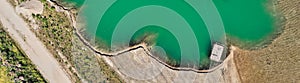 Geometrically shaped edge of a gravel quarry, abstract aerial view