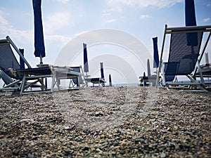 Geometries of umbrellas and deckchairs on the Italian beaches photo