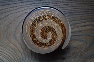 Geometry on the lid of the wooden jewelry box, sacred pattern, flower of life symbol, brass inlaid box