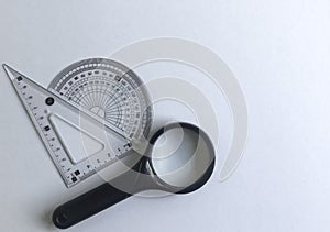 Geometry Measuring Tools with Magnifying Glass on White Background