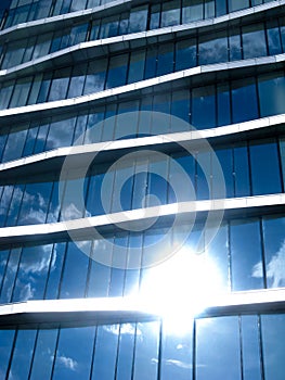 The geometry of a modern building with huge windows and glare of the sun