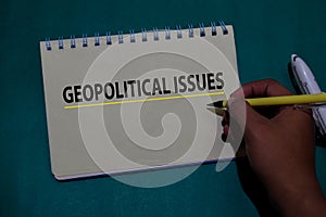 Geopolitical Issues write on a book isolated on Office Desk photo