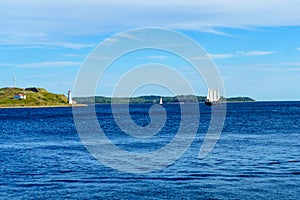 Georges Island lighthouse, and a sailboat, in Halifax