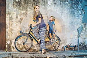 Georgetown, Penang, Malaysia - April 20, 2018: Mother and son on a bicycle. Public street art Name Children on a bicycle