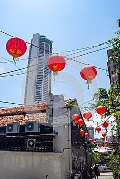 Red lantern at alley with background KOMTAR building.