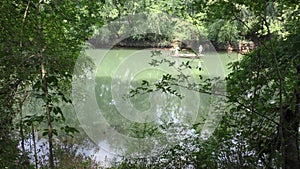 Georgia, Abbotts Bridge Park, A boat with two men fishing floats by on the Chattahoochee River