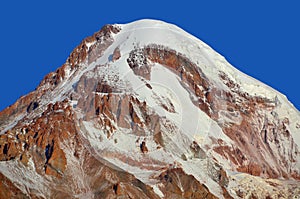 Georgia caucasus mountain landscape during a sunny day. Mount Kazbek is a dormant stratovolcano and one of the major mountains of