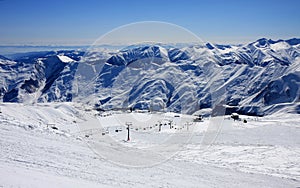 Georgia, mountains view with clouds from top view, snow landscape, blue skies