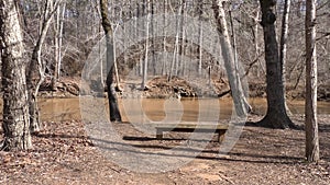 Georgia, Olde Rope Mill Rd Park, Wooden bench along the side of Little River