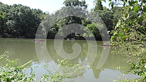 Georgia, Riverside Park, Two canoes rowing on the Chattahoochee River in the camera`s view