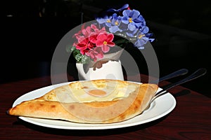 Georgian cheese pie Hachapuri in a restaurant of Tbilisi