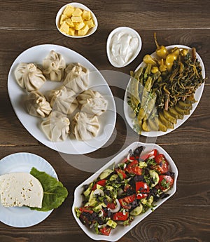 Georgian cuisine foodset from khinkali, cheese, pickles and salad,on the table