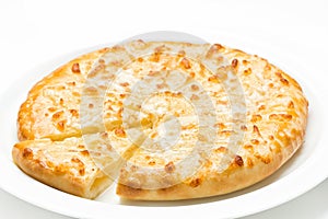 Georgian cuisine khachapuri with cheese freshly baked served on a white plate , close up on a white background