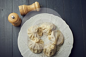 Georgian dumplings Khinkali with meat on white plate with copy space