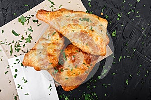 Georgian khachapuri - flatbread with cheese on dark wooden background