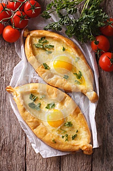 Georgian khachapuri and fresh vegetables closeup vertical top vi