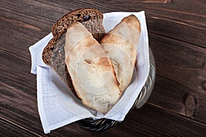 Georgian lavash, fresh pita bread, wheat flatbread in basket on wooden background.