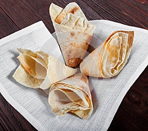 Georgian lavash, fresh pita bread, wheat flatbread in basket on wooden background.