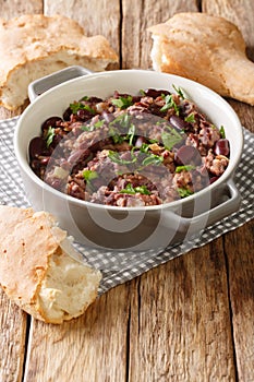 Georgian lobio recipe served with bread close-up in a pan. vertical