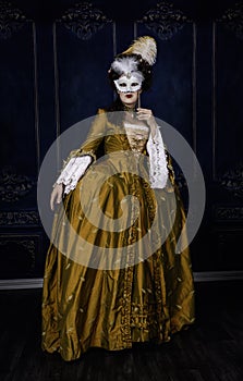 Georgian period woman wearing a silk dress and holding a mask photo