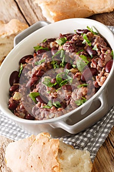 Georgian red bean lobio served with traditional bread close-up in a pan. vertical