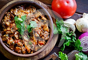 Georgian Satsivi with mushrooms onions and tomatoes in a clay pl