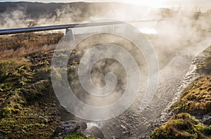 Geothermal Pipe in Grassy Landscape with Hot Spring
