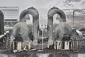 Geothermal power plant in falling snow storm