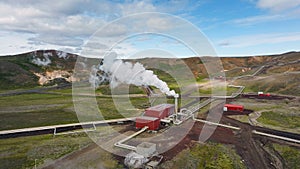 Geothermal power station in Icelandic landscape, steaming chimneys in a valley