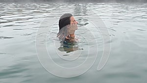 Geothermal spa. Woman relaxing in hot spring pool. Girl enjoying bathing opendoor basin with in warm mineral water 25fps