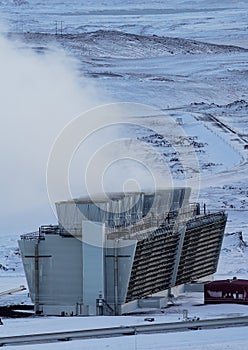 Geothermic plant with with smoke and snow in Iceland, vertical composition photo