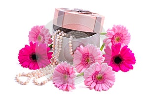 Gerbera flowers. Pink gerberas and pearls. Present.