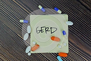 GERD write on sticky notes isolated on Wooden Table