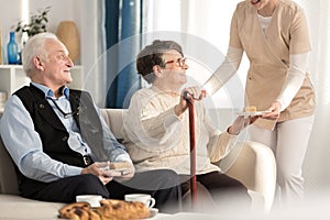 Geriatric couple with arthritis sitting photo