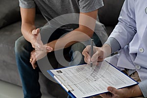 Geriatric doctor or geriatrician concept, Doctor visiting with patient in room and hearing serious disease diagnose writing on