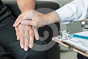 Geriatric doctor (geriatrician) consulting and diagnostic examining elderly senior adult patient on aging photo