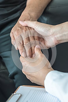 Geriatric doctor geriatrician consulting and diagnostic examining elderly senior adult patient older person on aging photo