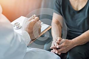 Geriatric doctor geriatrician consulting and diagnostic examining elderly senior adult patient older person on aging photo