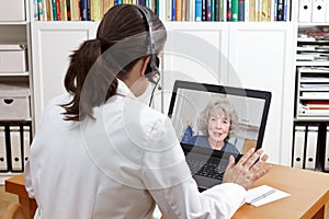 Geriatric doctor headset laptop patient photo